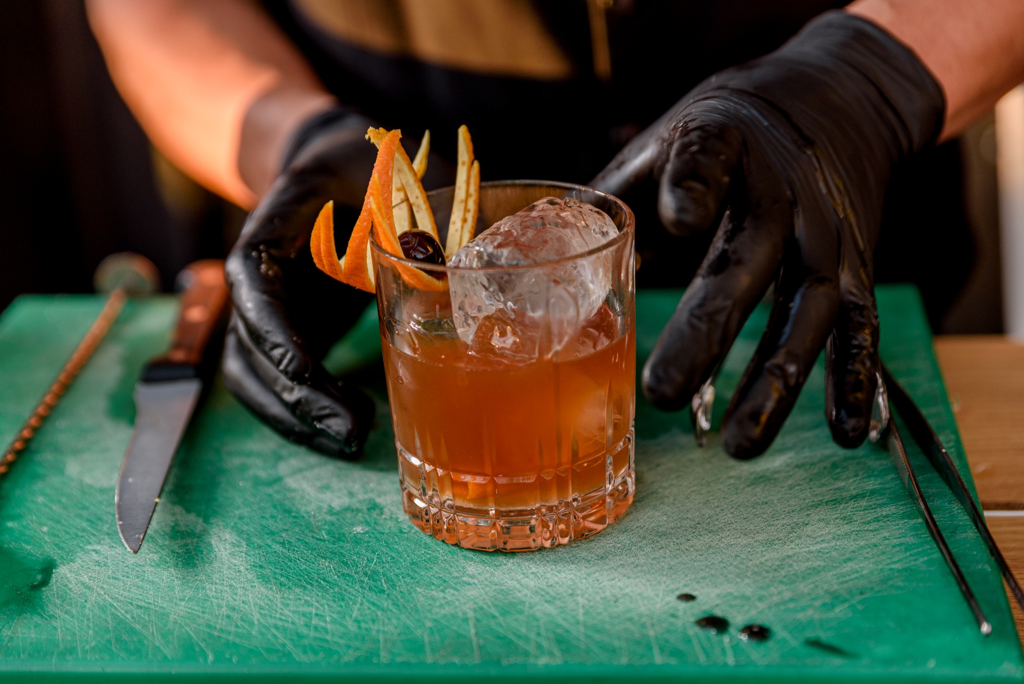 bartender preparing and decorating cocktails at the bar. profession concept